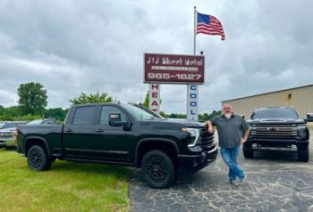J and J  truck with company owner outside their storefront. Call today for Kalamazoo Furnace repair.