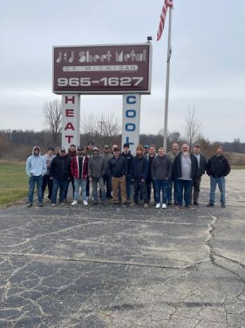 The team of Marshall’s best HVAC company standing out in front of our sign