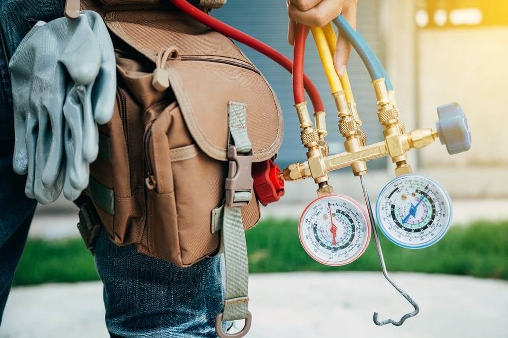 A J and J  technician with HVAC equipment in Battle Creek.
